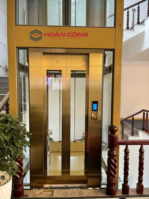 Thang máy kính inox vàng